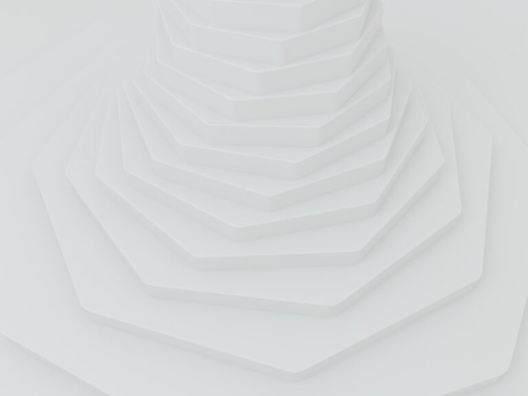 A series of white, hexagonal layers stacked on top of each other, creating a geometric, abstract pattern with soft shadows—ideal for showcasing unlimited WordPress support and edits in a modern website design.